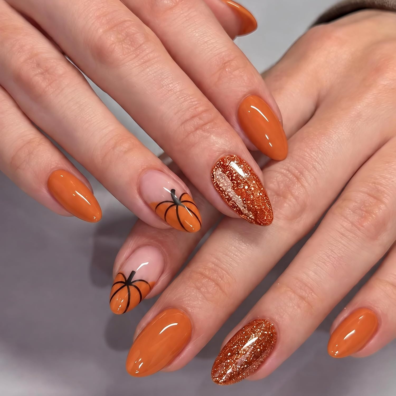image:imageUNA GELLA Halloween Press On Nails Short Almond 32Pcs Pumpkin Fake Nails Soft Gel Nail Tips Almond Shape in 16 Sizes with Semi Glue and Jelly Tabs Orange Glitter Finish for Party Fall ManicuresHallowween Glitter Short Almond